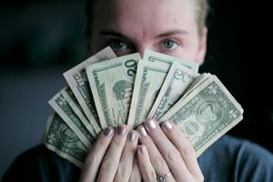 Person fanning out and holding cash