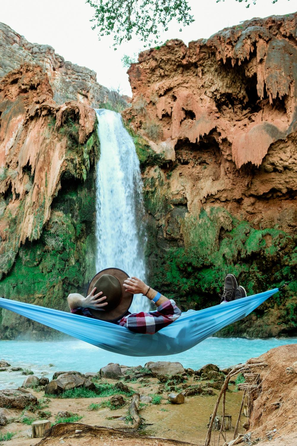 Man relaxing by a waterfall