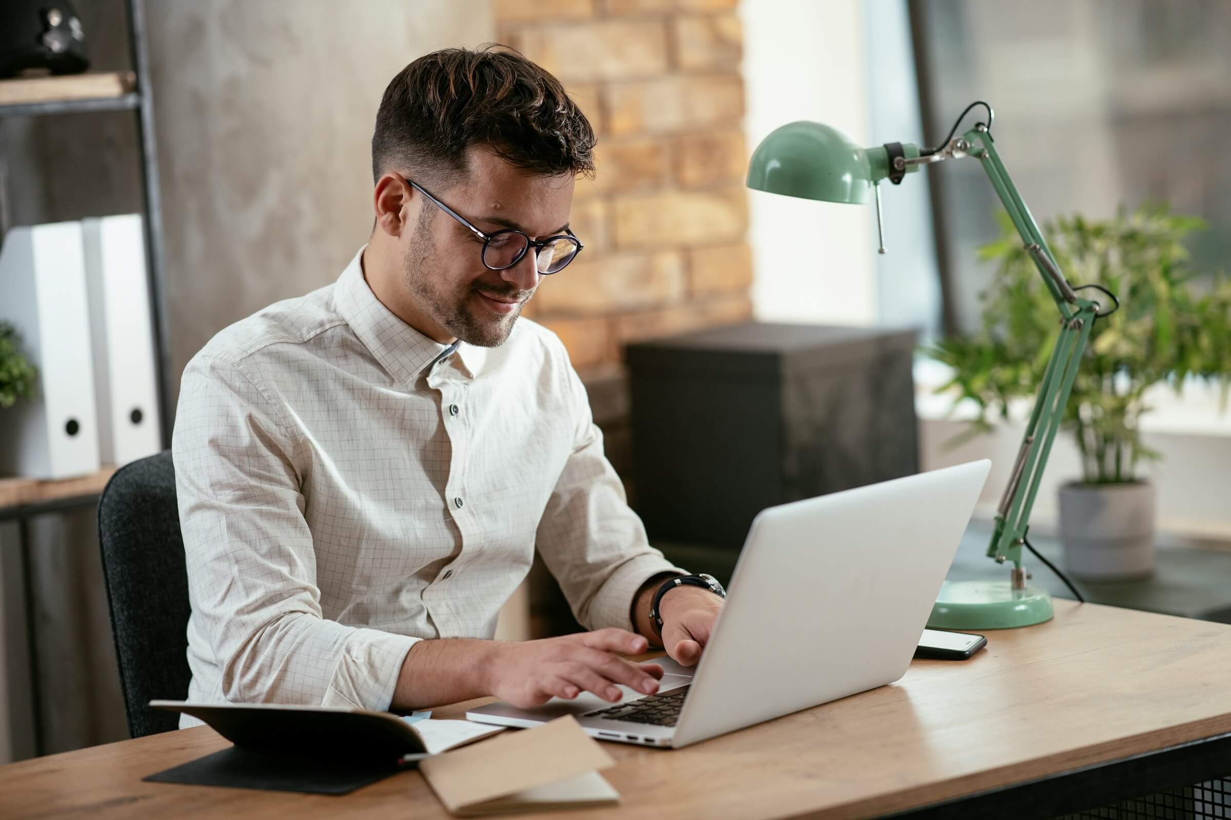 A restaurant manager working on a laptop in front of him