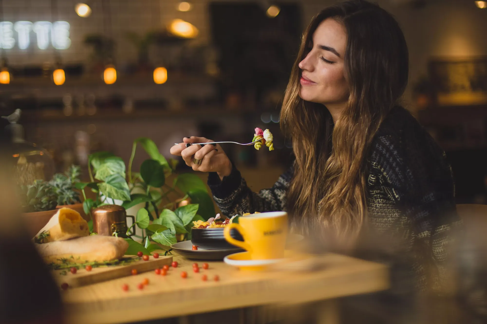 Woman enjoying food at a restaurant